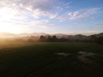 Scenic view of golf course against sky