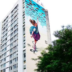 Man standing on skyscrapers against sky