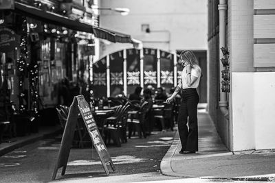 Rear view of people walking on street