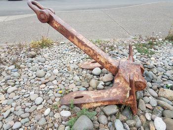 High angle view of rusty metal on rocks