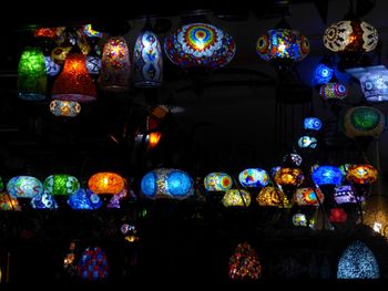 Illuminated lanterns hanging in the dark