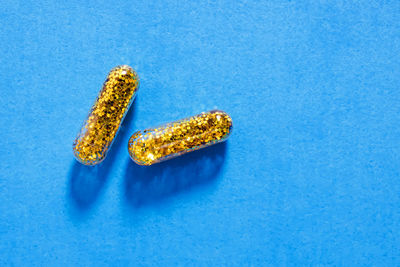 High angle view of pills on blue background