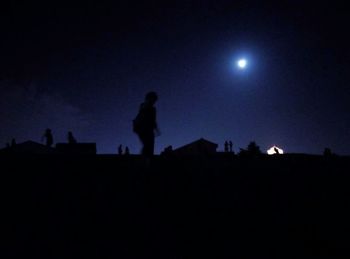 Low angle view of silhouette people against sky