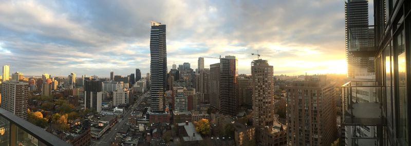 View of cityscape against cloudy sky