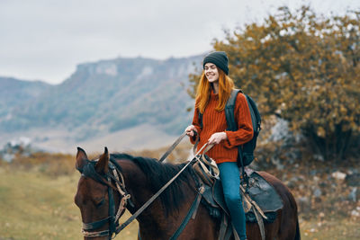 Portrait of young woman riding horse