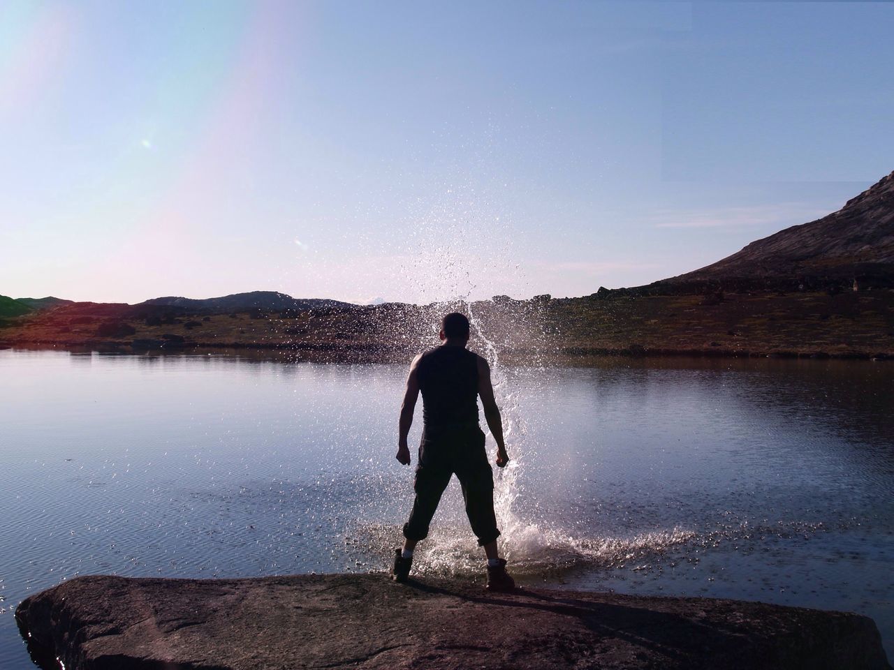 water, full length, rear view, lifestyles, leisure activity, standing, lake, reflection, tranquil scene, tranquility, sky, scenics, casual clothing, beauty in nature, nature, men, mountain, getting away from it all