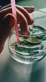 Close-up of cropped hand having drink