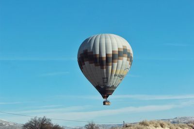 Low angle view of hot air balloon against blue sky