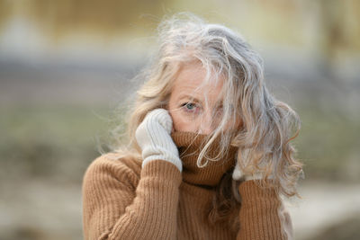 Portrait of a sixty-year-old woman with a gray hair