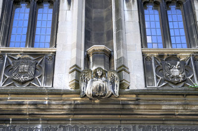 Low angle view of statue against building