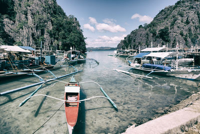 Boats moored in sea against sky
