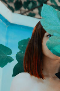 Portrait of a beautiful young woman in swimming pool