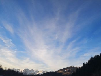 Low angle view of mountains against blue sky