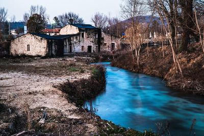 River amidst buildings against sky