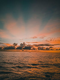 Scenic view of sea against romantic sky at sunset