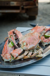 Close-up of grilled crab served on table outdoors