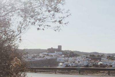 Buildings in city against clear sky