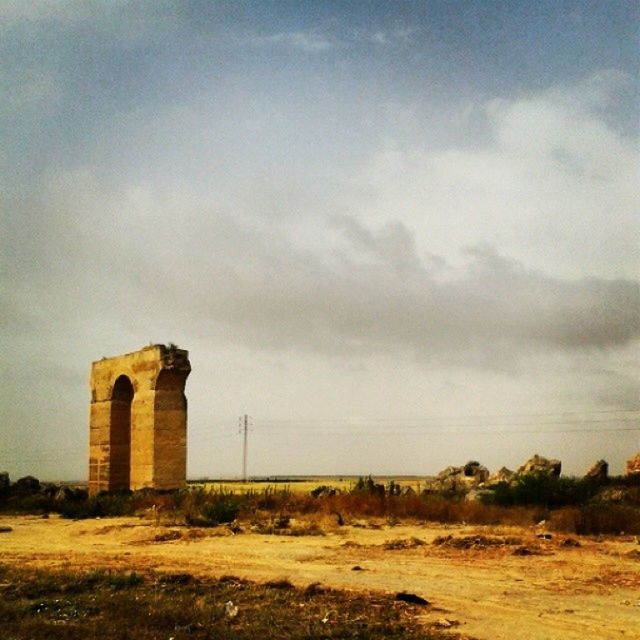 architecture, sky, built structure, building exterior, cloud - sky, field, landscape, cloudy, grass, rural scene, cloud, house, abandoned, nature, no people, outdoors, weather, day, old, damaged