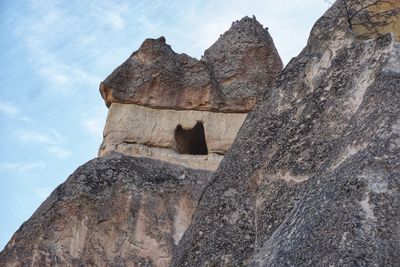 Low angle view of rock formation against sky