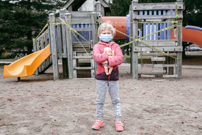 Full length of girl standing on playground