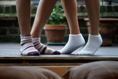 Low section of couple wearing socks at patio
