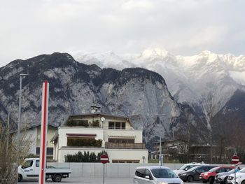 Cars on snow covered mountain against sky