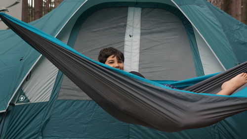 Portrait of boy lying in hammock