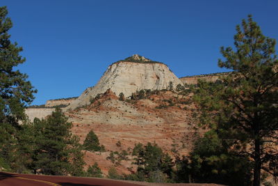 Low angle view of mountain against clear blue sky