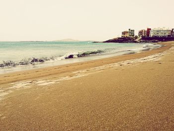 Scenic view of beach against clear sky