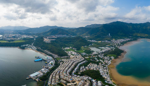 High angle view of river amidst cityscape against sky