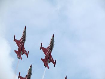 Low angle view of airplane flying against sky