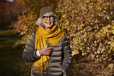 Portrait of senior woman in autumn scenery