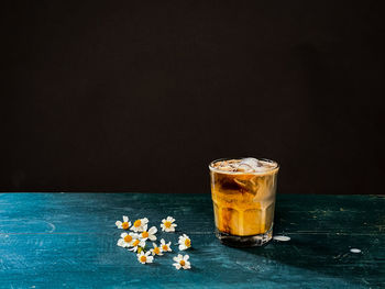 Close-up of drink on table against black background