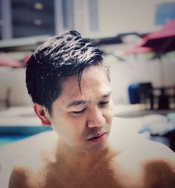 Portrait of shirtless man in bathroom