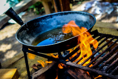 Close-up of food in container on barbecue grill