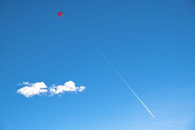 Low angle view of vapor trail against blue sky