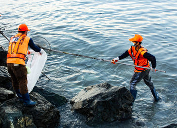 Man standing on boat in water