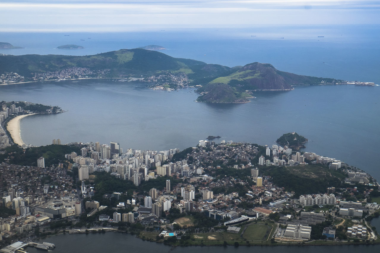 architecture, built structure, cityscape, building exterior, city, sea, water, high angle view, crowded, residential district, river, aerial view, sky, transportation, mountain, residential building, residential structure, coastline, town, city life