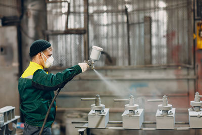 Side view of man working in workshop