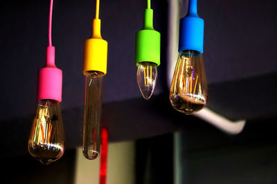 Close-up of illuminated lights hanging on metal