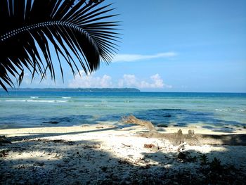 Scenic view of beach against blue sky