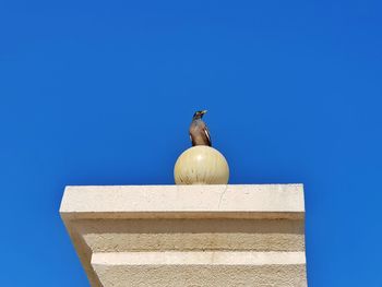 Low angle view of building against clear blue sky