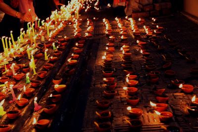 High angle view of diyas arranged on steps at night