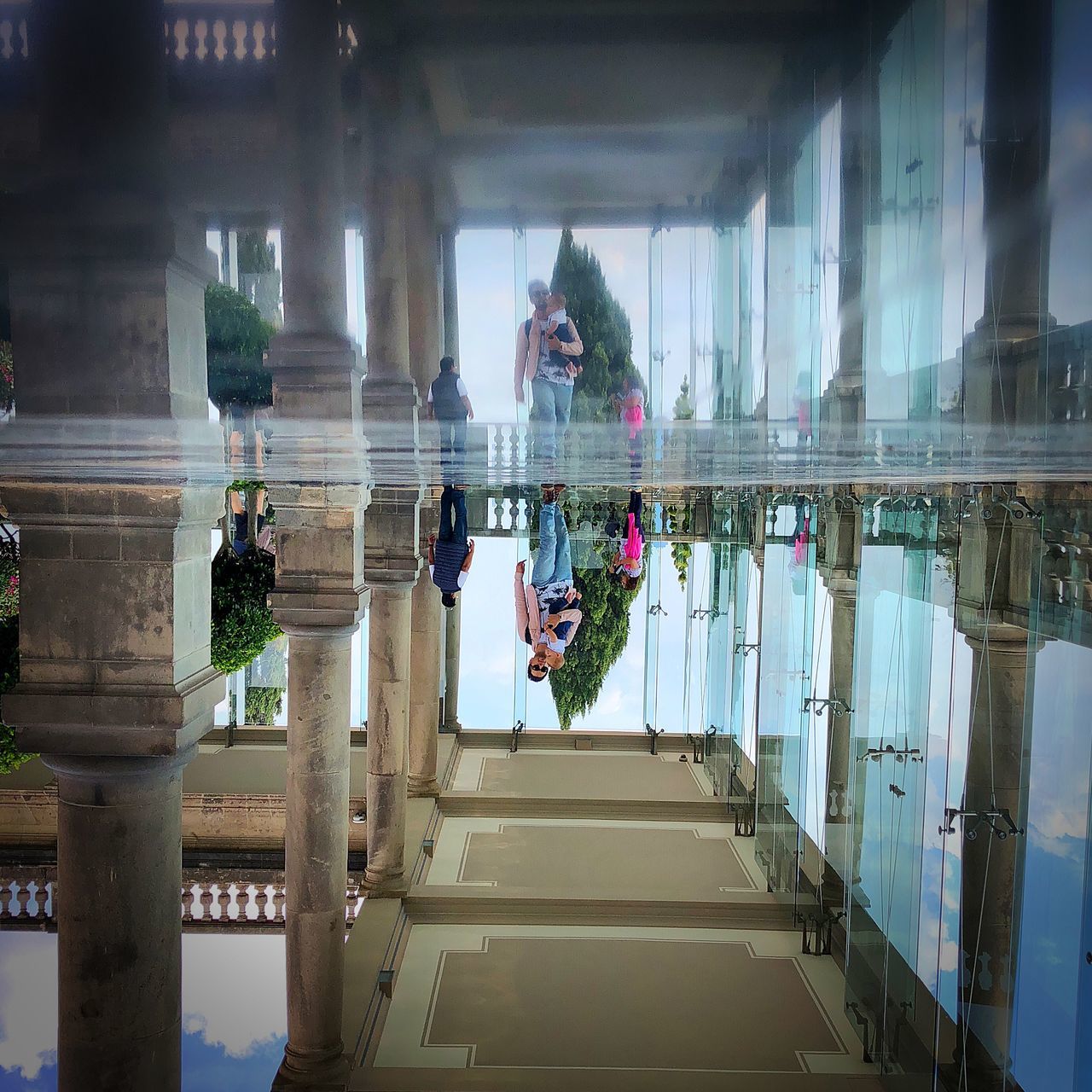 architecture, built structure, reflection, real people, day, women, architectural column, incidental people, one person, water, lifestyles, building exterior, men, nature, building, adult, window, outdoors, swimming pool, reflecting pool