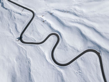Aerial view of winding road from above at dolomities,italy. snake road from above in winter season
