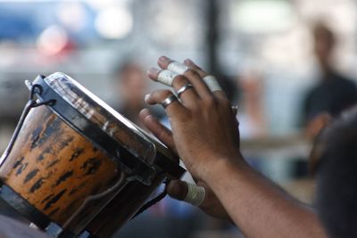 Cropped hands of musician playing instrument