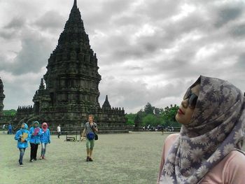 People at temple against sky