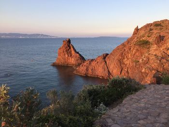 Scenic view of sea and mountains against clear sky