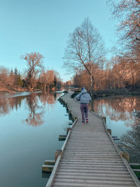 Pier over river against clear sky