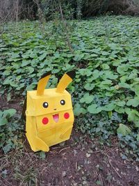 Close-up of yellow toy car on field